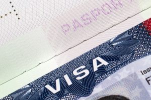 A close up of the word visa on top of a passport.